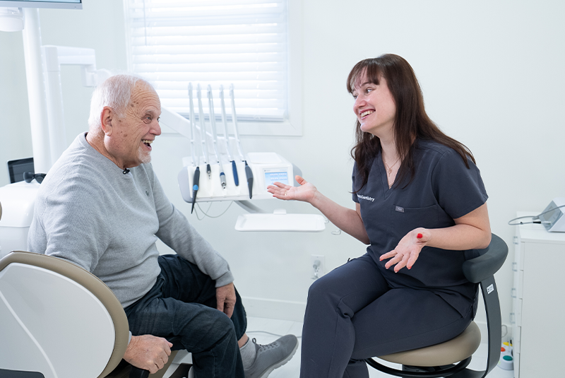 Patient and staff member discussing how to get started with dental implants